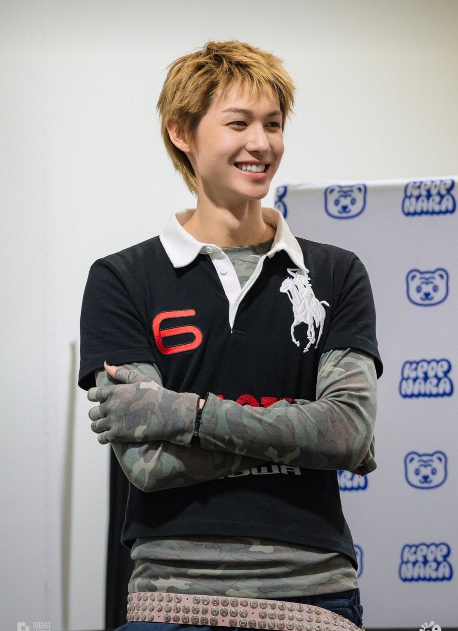 Martin of CORTIS smiling at a fansign in a vintage black Polo Ralph Lauren rugby shirt with a red number 6 and a white collar