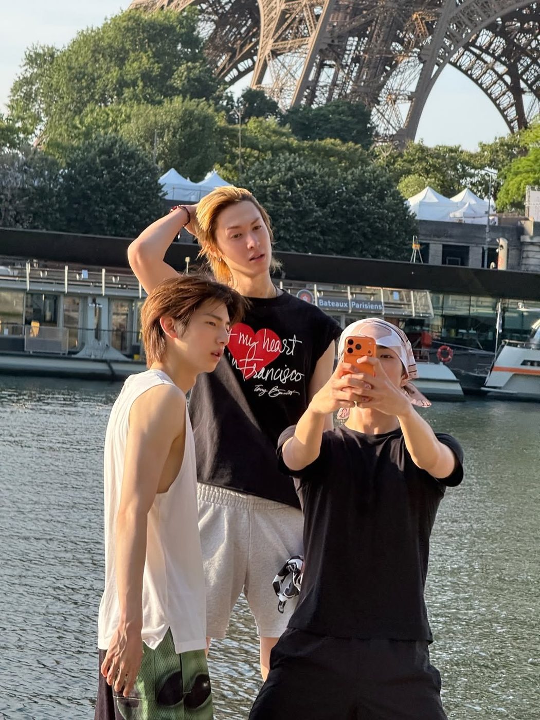Martin of CORTIS wearing his vintage 90s Tony Bennett I Left My Heart in San Francisco t-shirt in Paris by the Seine with the Eiffel Tower behind