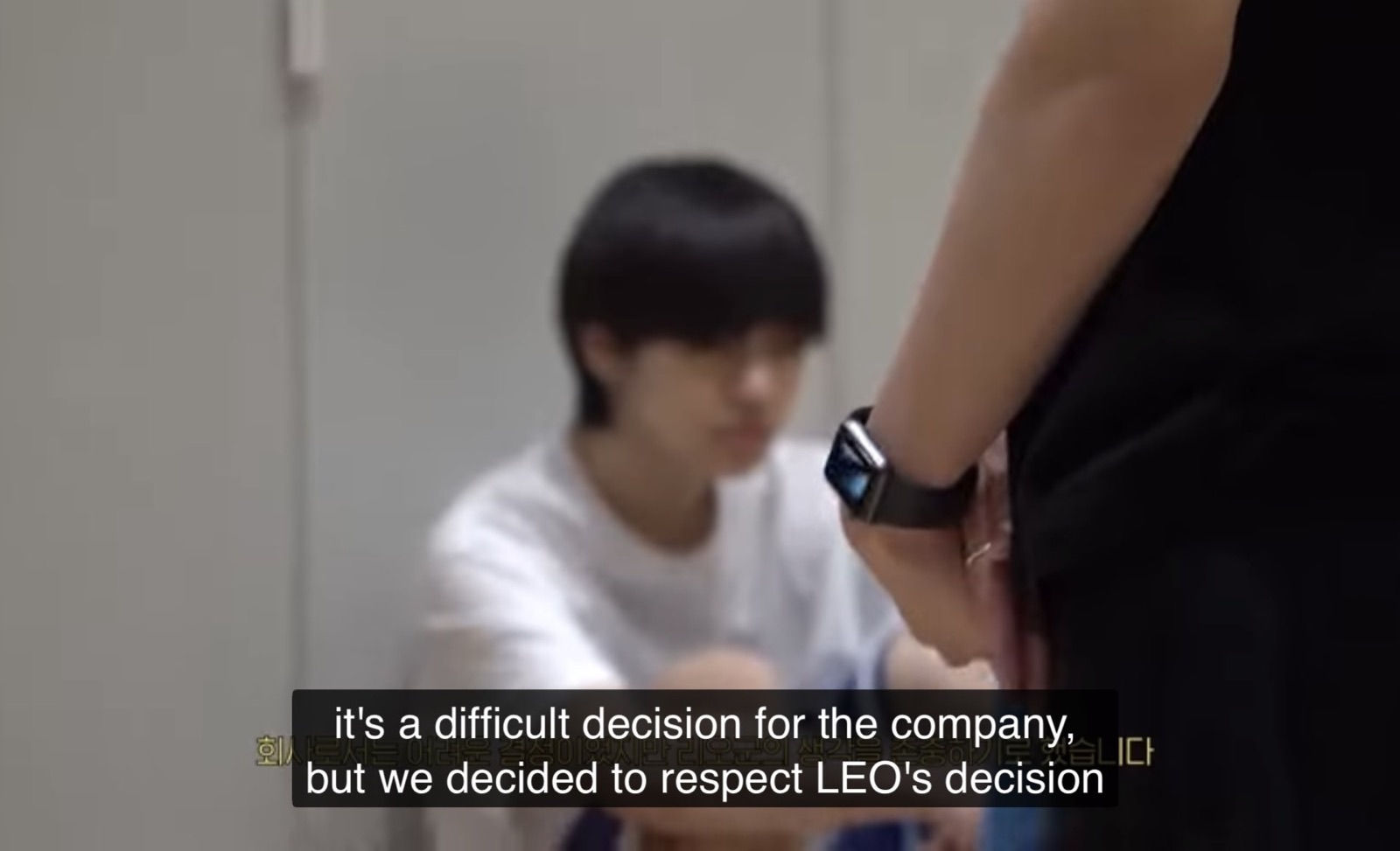 Leo sitting with his head down as the company explains it accepted his decision