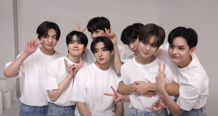 The seven members of Trainee A in white t-shirts, the Big Hit pre-debut group that never debuted