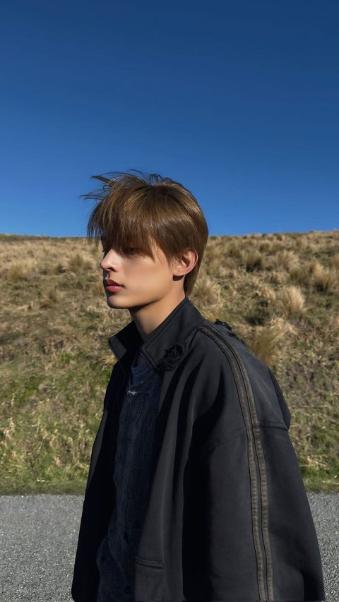 CORTIS James phone wallpaper, debut era, black jacket against a blue sky