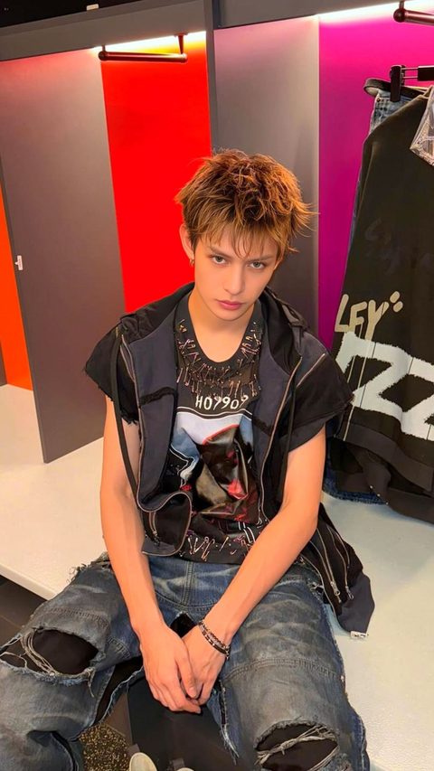 CORTIS James phone wallpaper, sitting in ripped denim and a zipped vest backstage