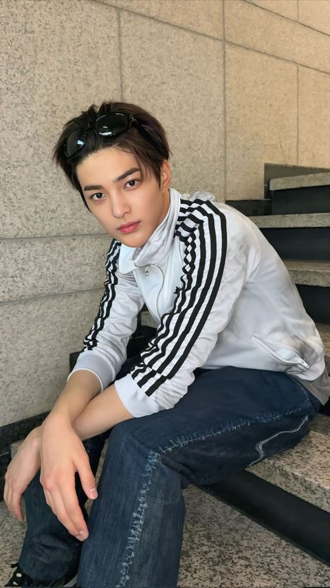CORTIS Keonho phone wallpaper, sitting on stone steps in a white adidas track jacket