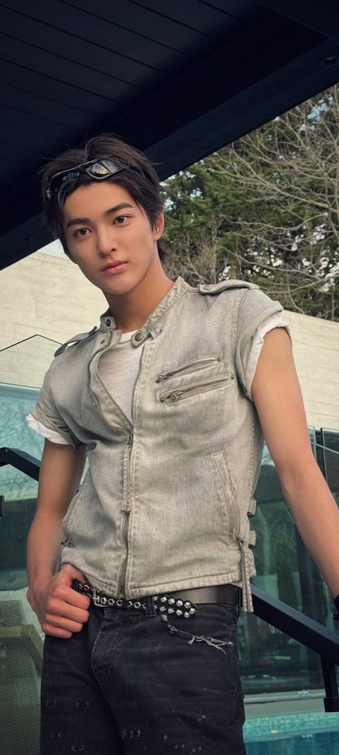 CORTIS Keonho phone lock screen, denim vest and studded belt by a pool