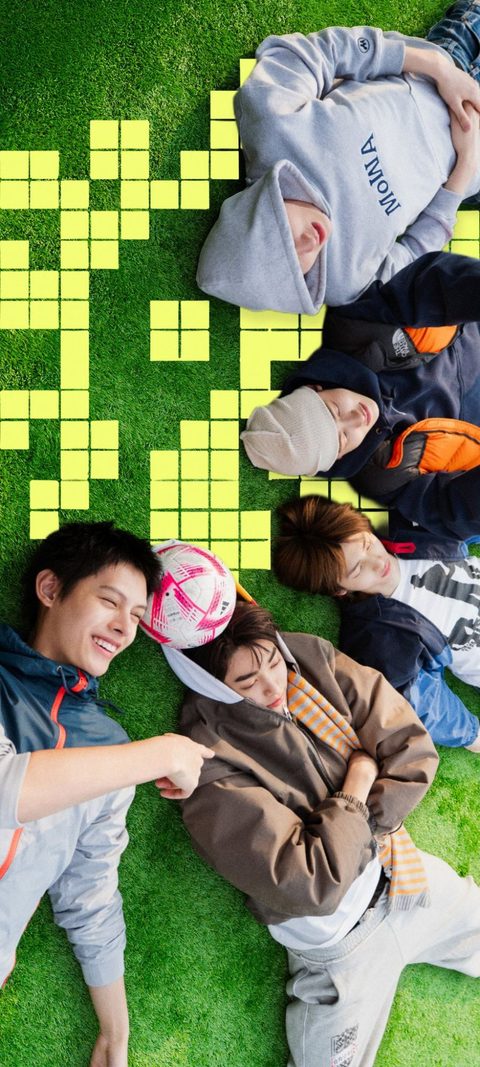 CORTIS phone wallpaper, the five members lying on a green football pitch