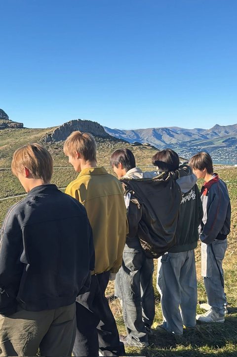 CORTIS phone wallpaper, the five members from behind looking over the mountains