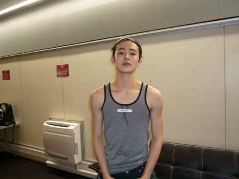 CORTIS Seonghyeon laptop and iPad wallpaper, backstage in Barcelona in a striped tank top